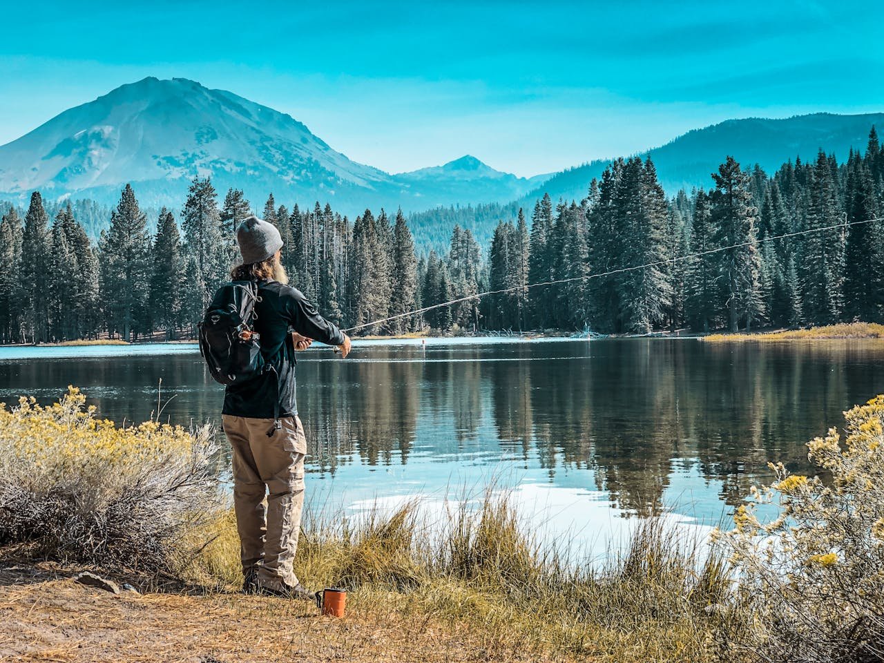 pexels-traveling-inka-2741986-5619244 Fisherman by a lake with camping tent and outdoor gear representing MAXELTI Active fishing and camping essentials