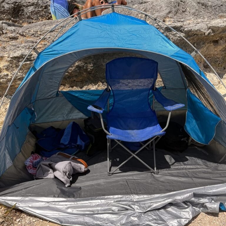 Night Cat beach tent interior with a camp chair inside, showing the grey floor and a side mesh window